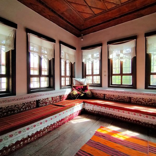 An empty yoga mat on a wooden floor near a window.