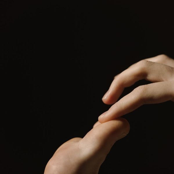 Close-up of hands in a meditative gesture.